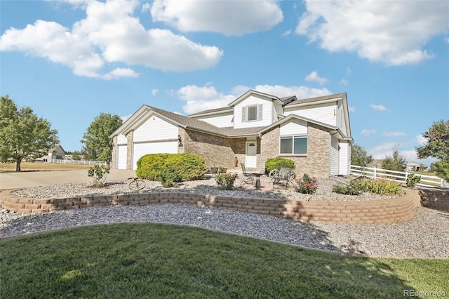 view of front of property featuring a garage and a front lawn