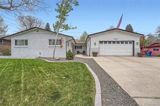 1025 Zang St, Golden, CO 80401 - single story home featuring an attached garage, brick siding, a front yard, and concrete driveway
