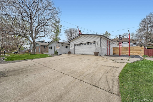 1025 Zang St, Golden, CO 80401 - view of front of home featuring brick siding, fence, and a front yard