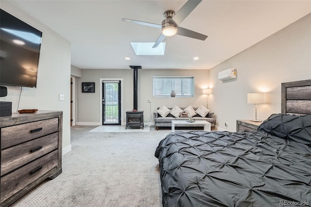 1025 Zang St, Golden, CO 80401 - carpeted bedroom with recessed lighting, a skylight, a wood stove, and a wall mounted air conditioner