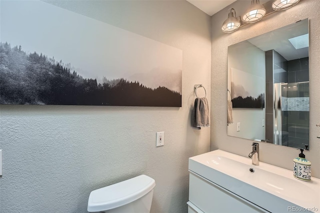 1025 Zang St, Golden, CO 80401 - full bathroom featuring a skylight, vanity, a shower stall, and toilet