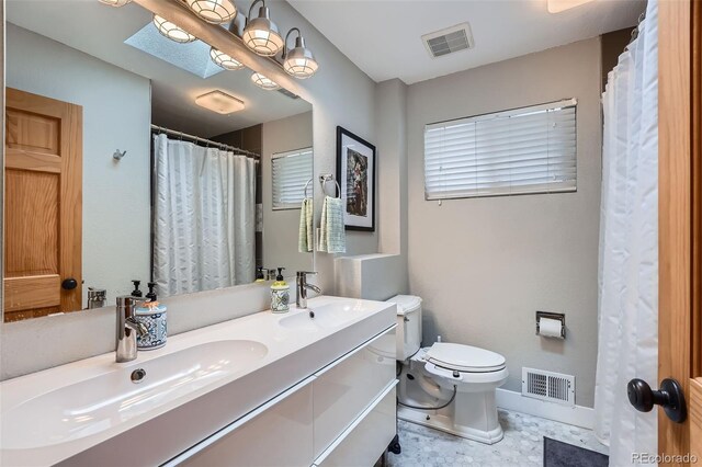 1025 Zang St, Golden, CO 80401 - bathroom with visible vents, a sink, double vanity, and toilet