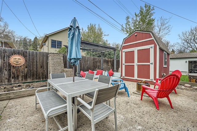 1025 Zang St, Golden, CO 80401 - view of patio with a fenced backyard, a storage unit, an outdoor structure, and outdoor dining area