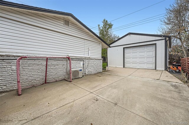1025 Zang St, Golden, CO 80401 - detached garage with fence, driveway, and central AC unit