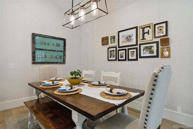 7440 Quail St, Arvada, CO 80005 - dining room with wood finished floors and a chandelier