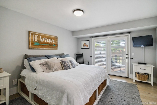 7440 Quail St, Arvada, CO 80005 - bedroom with access to exterior and light wood-style flooring