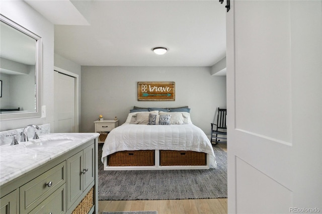 7440 Quail St, Arvada, CO 80005 - bedroom featuring a sink and light wood finished floors