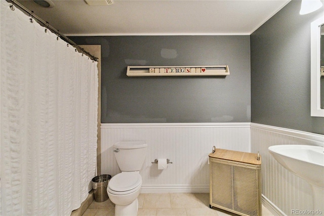 7440 Quail St, Arvada, CO 80005 - full bath with wainscoting, tile patterned flooring, and a shower with shower curtain