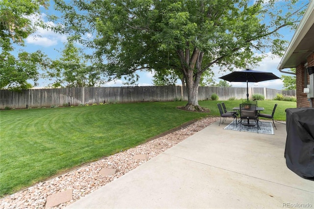 7440 Quail St, Arvada, CO 80005 - fenced backyard featuring a patio area and outdoor dining space