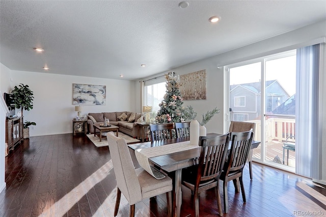 dining space featuring a textured ceiling and dark hardwood / wood-style floors