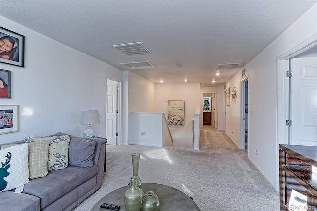 living room featuring light carpet and a textured ceiling