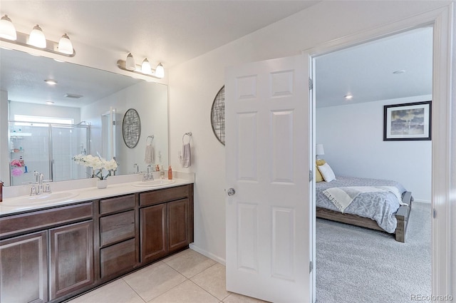 bathroom with vanity, tile patterned floors, and a shower with shower door