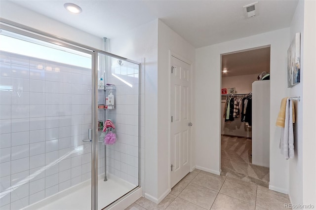 bathroom featuring tile patterned floors and a shower with door