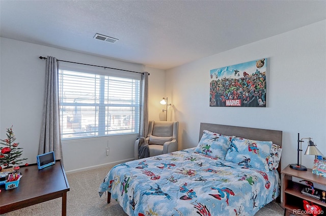 bedroom featuring carpet and a textured ceiling