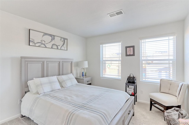 bedroom featuring light carpet