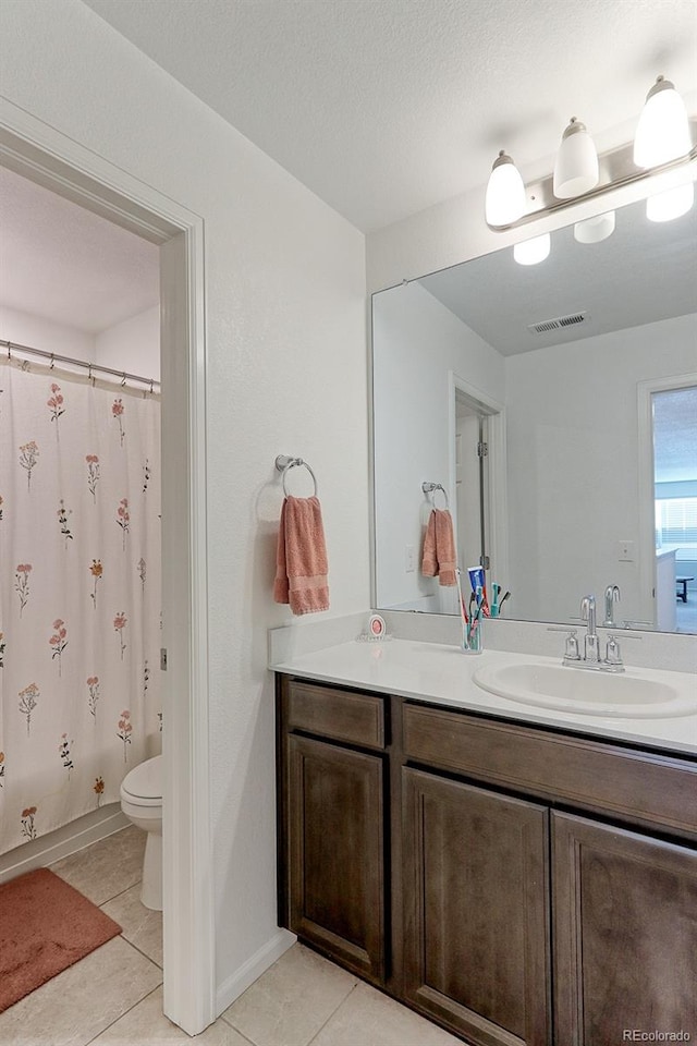 full bathroom featuring vanity, shower / bath combination with curtain, tile patterned flooring, toilet, and a textured ceiling