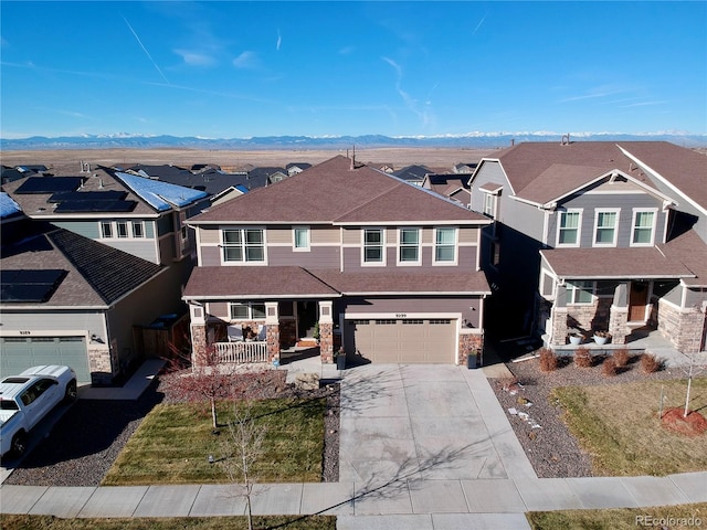 view of front of house with a mountain view, a porch, and a garage