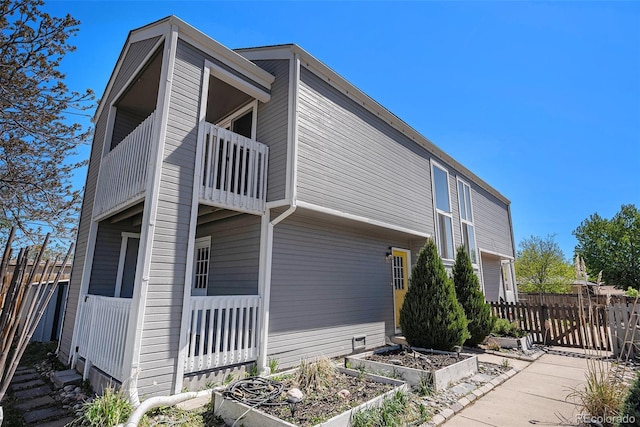1403 Valentia St, Denver, CO 80220 - view of home's exterior with a balcony and a garden