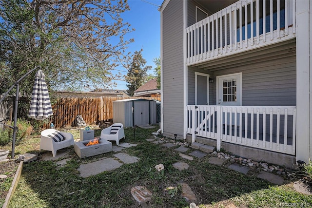 1403 Valentia St, Denver, CO 80220 - view of yard with a storage unit, a fire pit, and a balcony