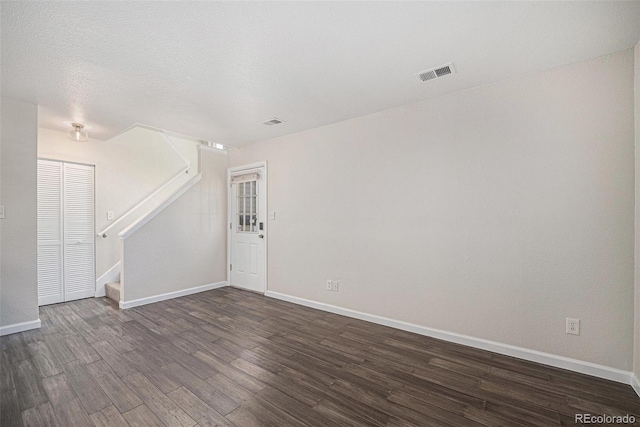 1403 Valentia St, Denver, CO 80220 - empty room featuring dark wood-type flooring and stairway