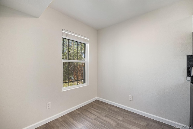 1403 Valentia St, Denver, CO 80220 - spare room featuring wood finished floors and baseboards