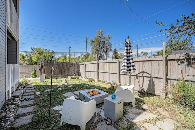 1403 Valentia St, Denver, CO 80220 - fenced backyard with a fire pit