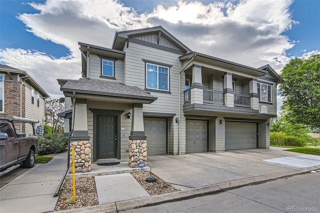 13151 Grant Cir N Unit C, Thornton, CO 80241 - view of front facade featuring an attached garage, driveway, board and batten siding, and a balcony