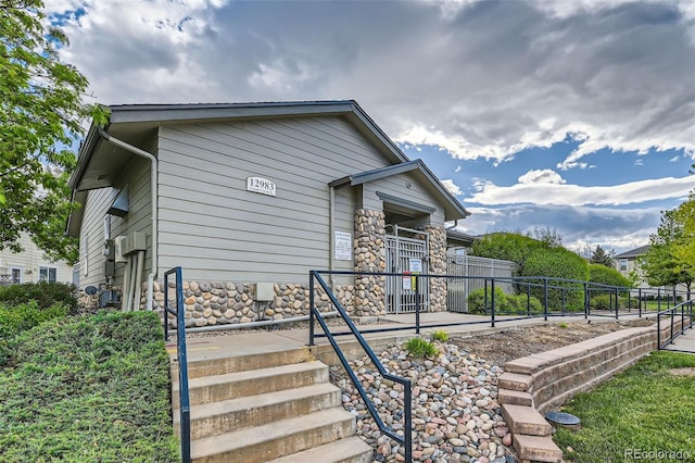 13151 Grant Cir N Unit C, Thornton, CO 80241 - view of property exterior featuring stone siding