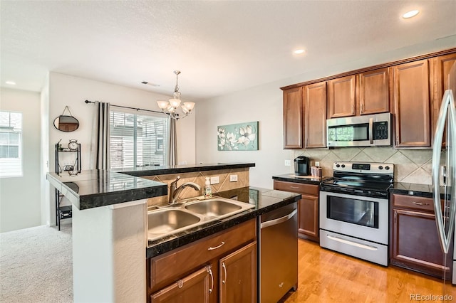 13151 Grant Cir N Unit C, Thornton, CO 80241 - kitchen with appliances with stainless steel finishes, a sink, healthy amount of natural light, a chandelier, and recessed lighting