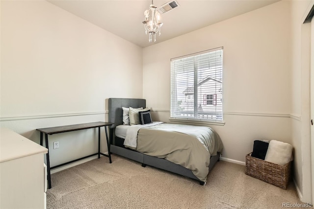 13151 Grant Cir N Unit C, Thornton, CO 80241 - bedroom with light colored carpet, a chandelier, and baseboards