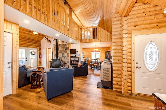 7573 Pine Crest Dr, Kiowa, CO 80117 - entrance foyer with a wood stove, wood ceiling, wood finished floors, high vaulted ceiling, and log walls