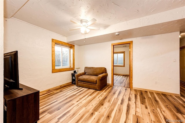 7573 Pine Crest Dr, Kiowa, CO 80117 - sitting room with light wood finished floors, a ceiling fan, and a textured wall
