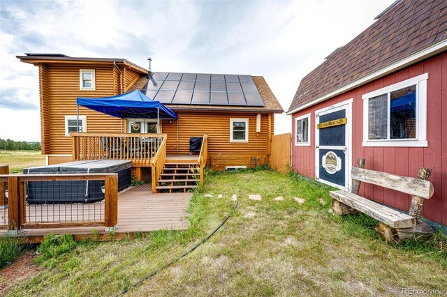 7573 Pine Crest Dr, Kiowa, CO 80117 - rear view of property with a standing seam roof, log exterior, a deck, a metal roof, and solar panels