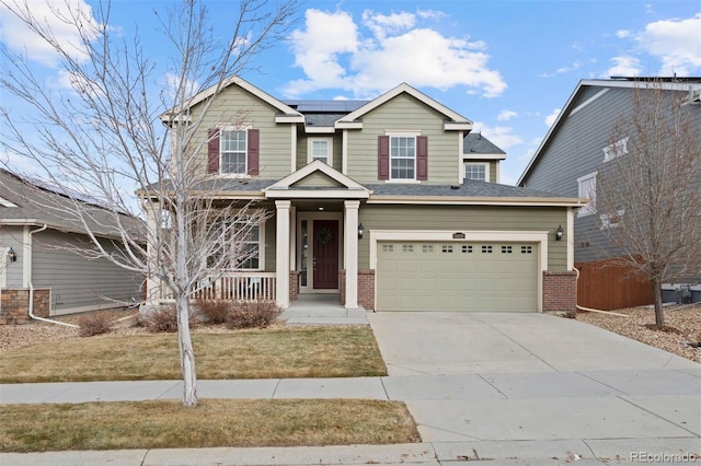 view of front of property with a front lawn, a garage, and solar panels