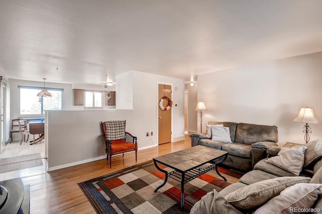 living room with light wood-type flooring and baseboards