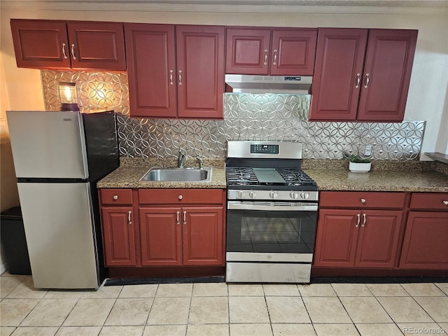 kitchen with decorative backsplash, light tile patterned floors, stainless steel appliances, and sink