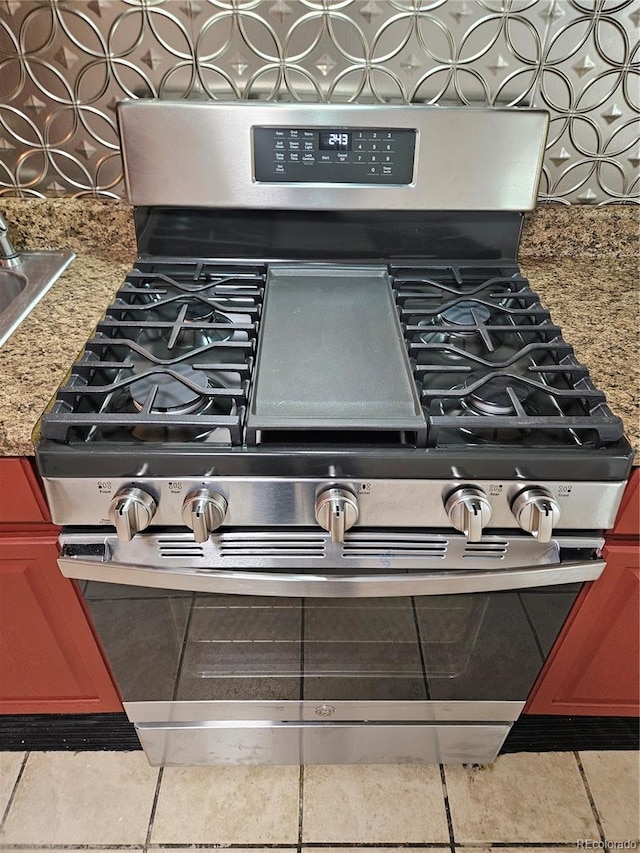 details featuring stone countertops and stainless steel range with gas stovetop