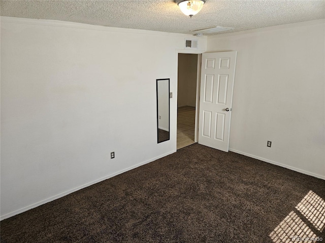 carpeted empty room featuring a textured ceiling and ornamental molding