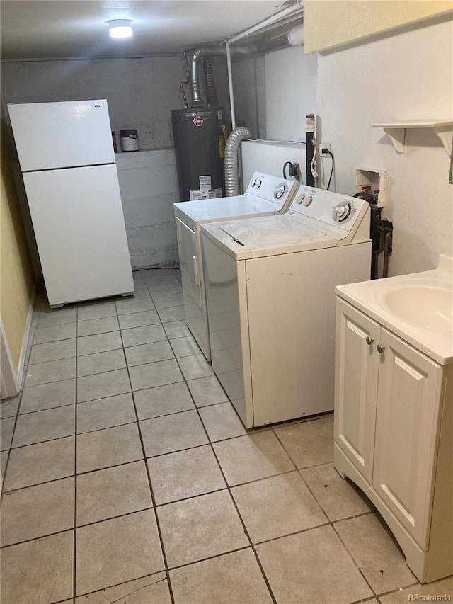 laundry room with cabinets, gas water heater, sink, washer and dryer, and light tile patterned flooring