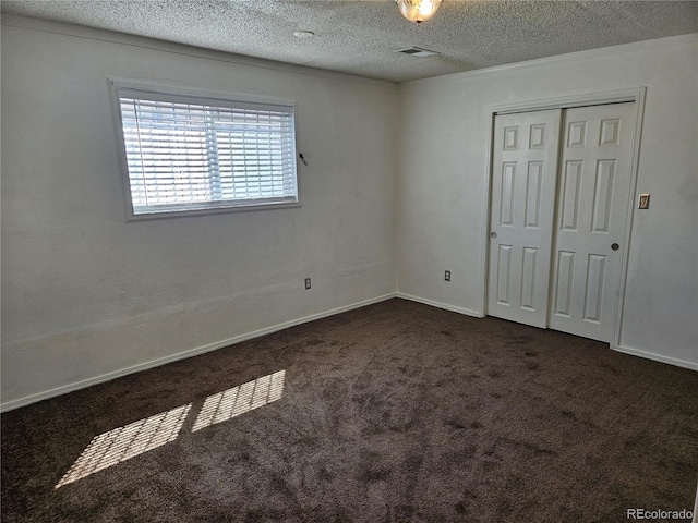 interior space featuring ornamental molding and a textured ceiling