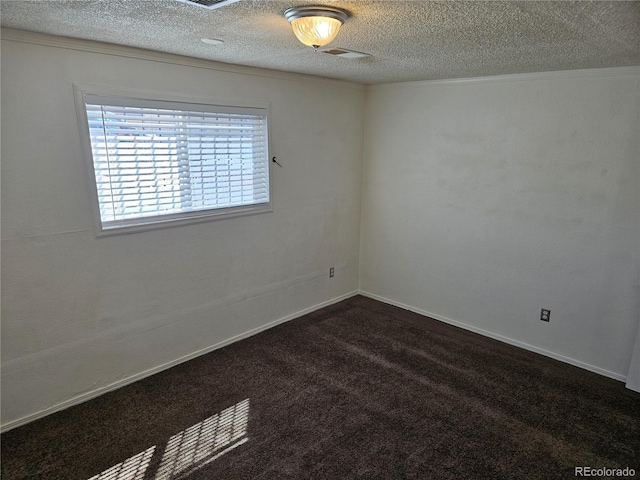 carpeted empty room featuring a textured ceiling