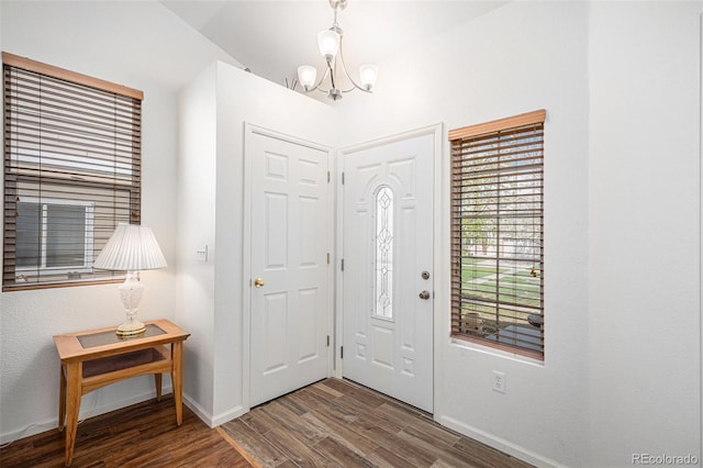 19628 E 58th Pl, Aurora, CO 80019 - entryway featuring a chandelier, baseboards, wood finished floors, and lofted ceiling