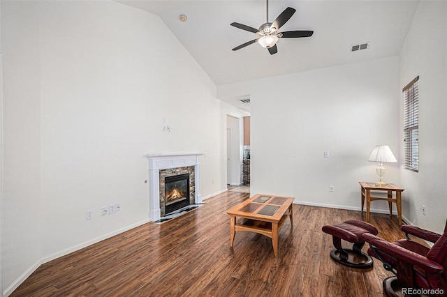 19628 E 58th Pl, Aurora, CO 80019 - living area featuring high vaulted ceiling, ceiling fan, wood finished floors, a stone fireplace, and baseboards