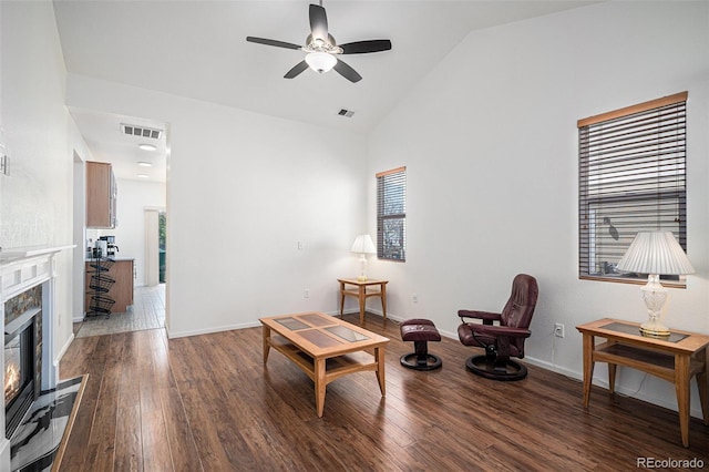 19628 E 58th Pl, Aurora, CO 80019 - living area featuring ceiling fan, wood finished floors, healthy amount of natural light, vaulted ceiling, and a fireplace