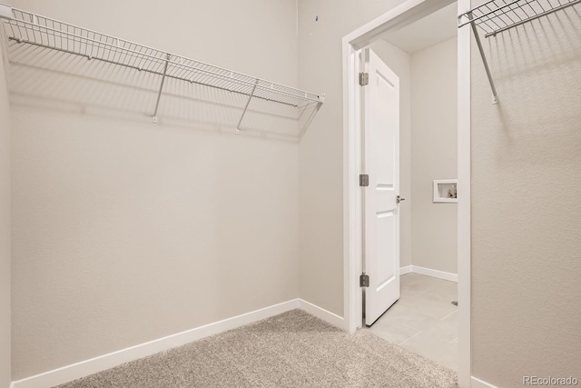 spacious closet featuring light carpet