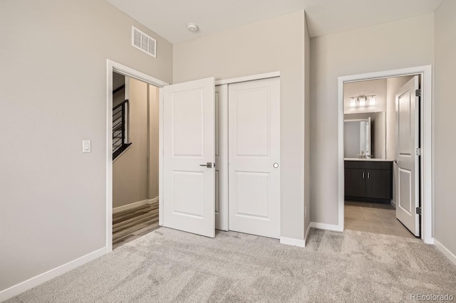 unfurnished bedroom featuring light carpet and baseboards