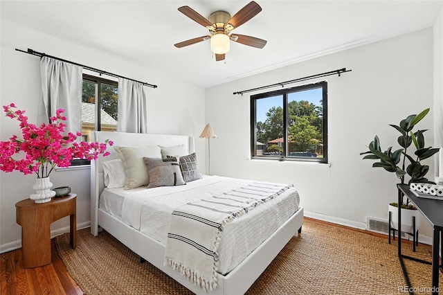 2955 Poplar St, Denver, CO 80207 - bedroom with multiple windows, wood finished floors, and a ceiling fan