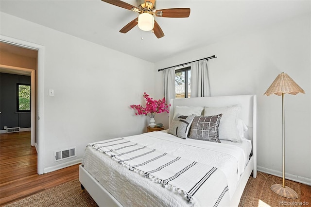 2955 Poplar St, Denver, CO 80207 - bedroom with multiple windows, wood finished floors, and ceiling fan
