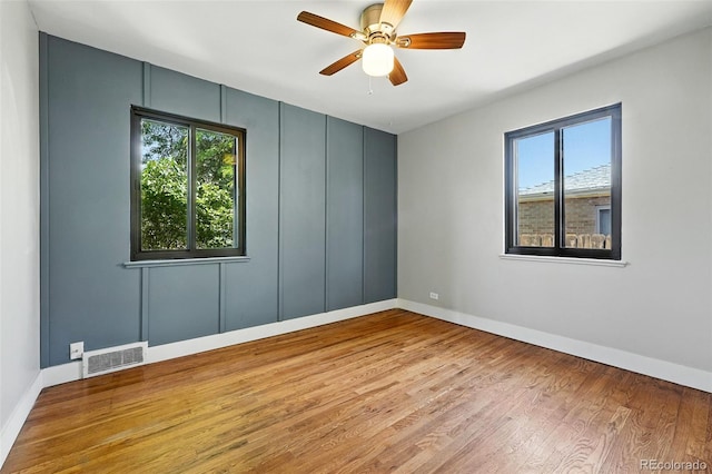 2955 Poplar St, Denver, CO 80207 - empty room with plenty of natural light, wood finished floors, and a ceiling fan
