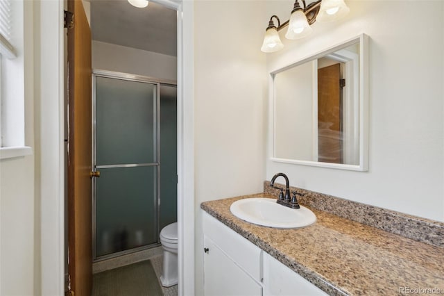 1422 N Chelton Rd, Colorado Springs, CO 80909 - full bath featuring a shower stall, vanity, toilet, and tile patterned flooring